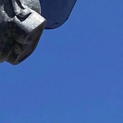Blue sky beside a sculpture, taken by phone A